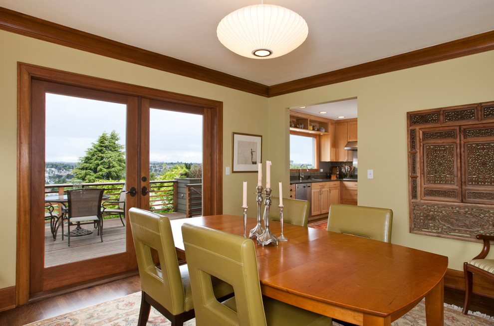 Inspiration for a traditional dining room in Seattle with beige walls and dark hardwood floors.