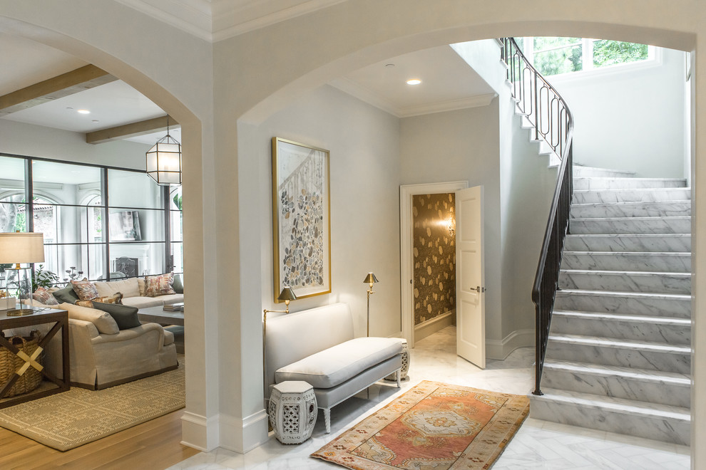 Design ideas for a transitional foyer in Dallas with white walls and marble floors.