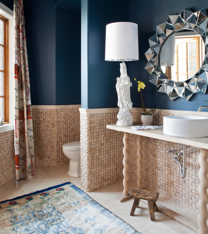 This is an example of a transitional powder room in Denver with a vessel sink and blue walls.