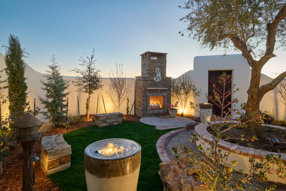 Inspiration for a small eclectic courtyard xeriscape garden in Other with a fireplace and gravel.