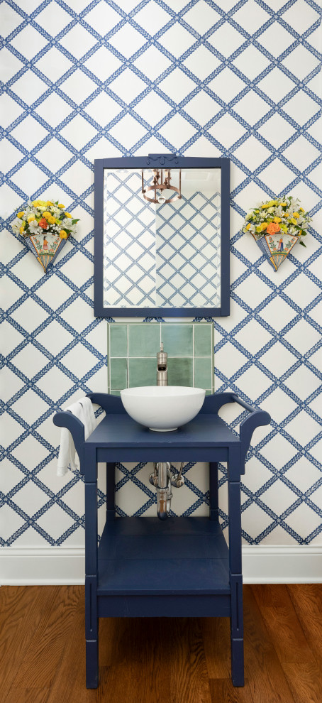 Small nautical cloakroom in Minneapolis with blue cabinets, a one-piece toilet, green tiles, ceramic tiles, blue walls, medium hardwood flooring, a vessel sink, wooden worktops, brown floors, blue worktops, a freestanding vanity unit and wallpapered walls.