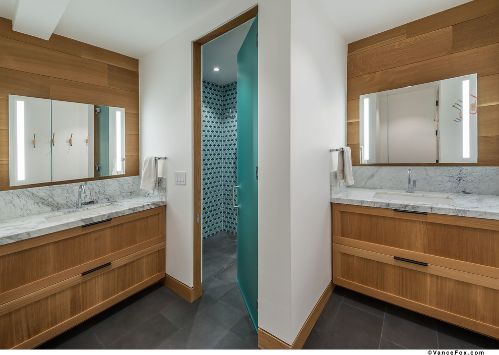 Inspiration for a large contemporary kids wet room bathroom in Other with recessed-panel cabinets, medium wood cabinets, a wall-mount toilet, blue tile, mosaic tile, white walls, slate floors, a trough sink, engineered quartz benchtops, grey floor, a hinged shower door and multi-coloured benchtops.