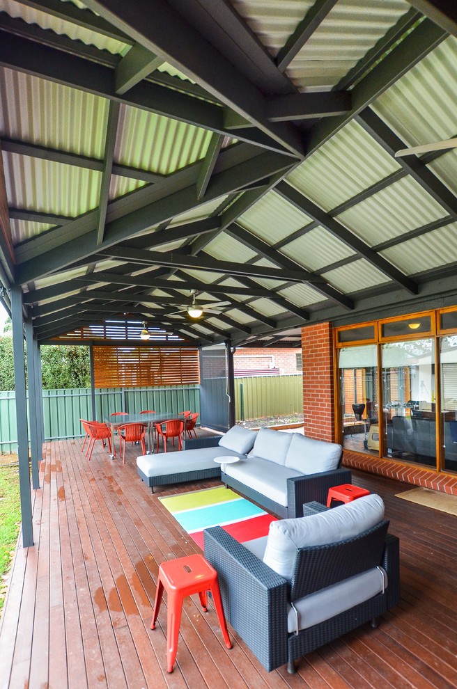 Photo of a large contemporary backyard deck in Adelaide with a pergola.