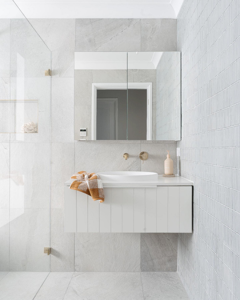 This is an example of a small beach style kids wet room bathroom in Perth with shaker cabinets, white cabinets, a drop-in tub, gray tile, porcelain tile, grey walls, porcelain floors, a drop-in sink, solid surface benchtops, grey floor, an open shower, white benchtops, a single vanity and a floating vanity.