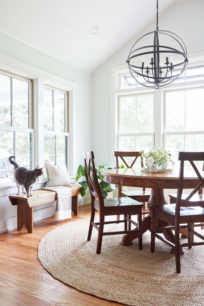 This is an example of a mid-sized country separate dining room in Richmond with white walls, medium hardwood floors, no fireplace and brown floor.