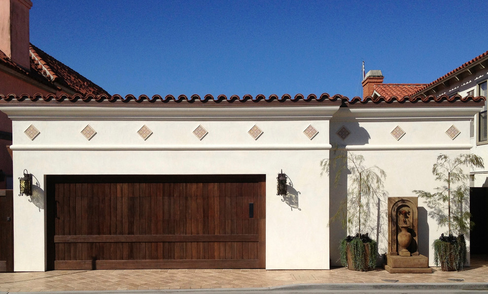 Design ideas for a large mediterranean one-storey stucco beige exterior in Orange County with a flat roof.