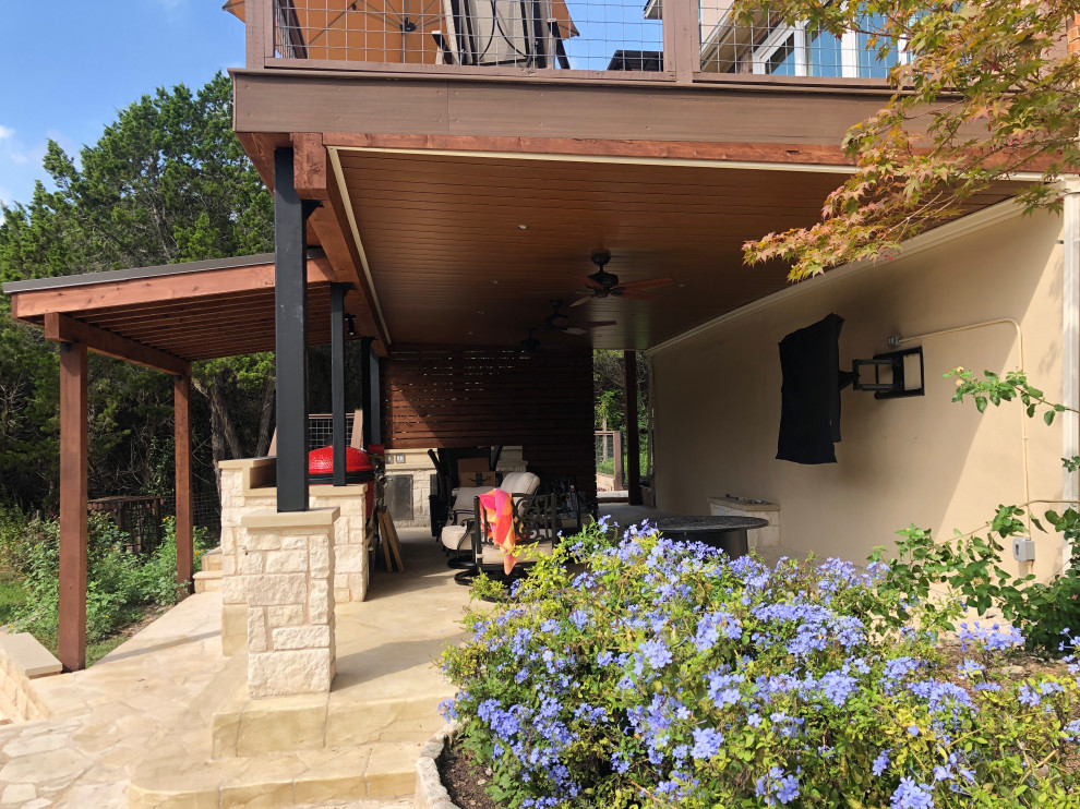 This is an example of an expansive eclectic back first floor mixed railing terrace in Austin with an outdoor kitchen.