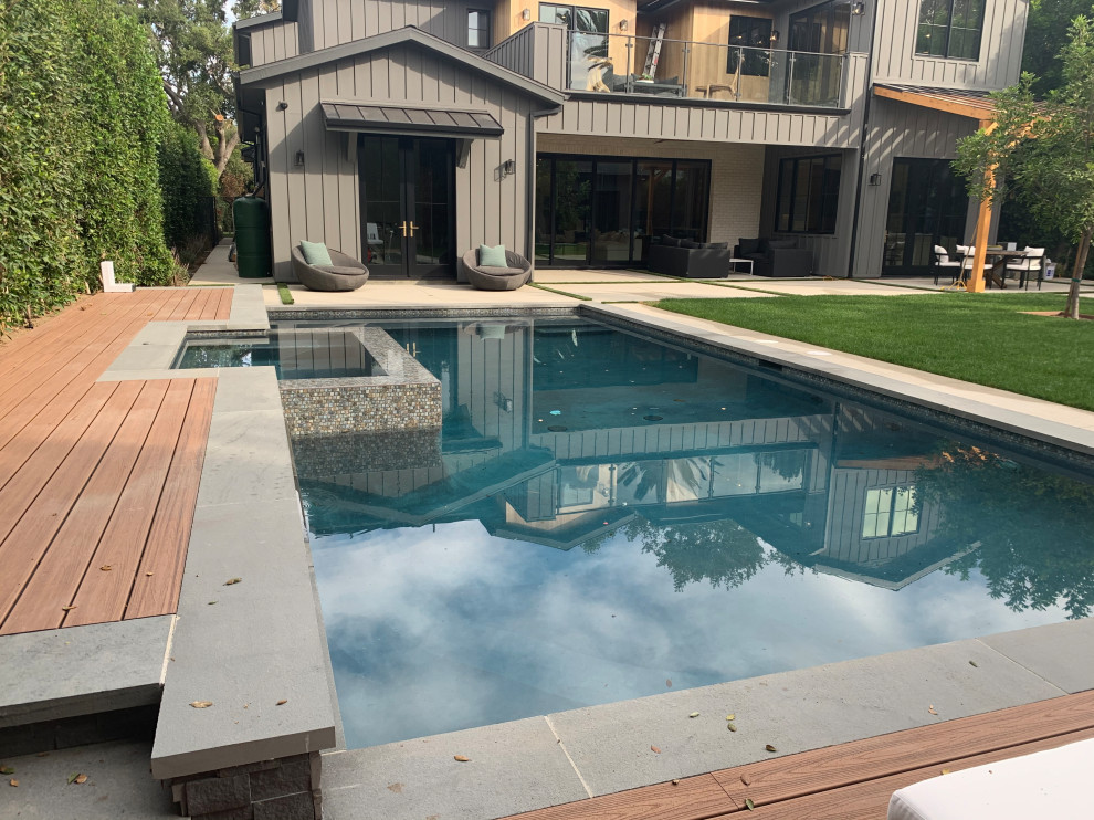 Design ideas for a mid-sized modern backyard rectangular pool in Los Angeles with decking.