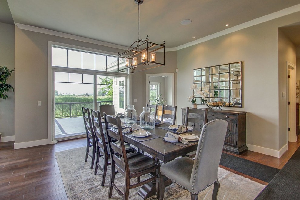Example of a large transitional medium tone wood floor and brown floor great room design with gray walls and no fireplace