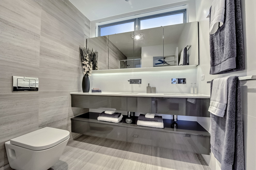 Contemporary bathroom in Brisbane with flat-panel cabinets, grey cabinets and a wall-mount toilet.
