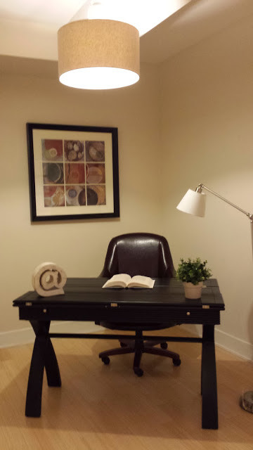 Photo of a small contemporary study room in DC Metro with beige walls, light hardwood floors and a freestanding desk.