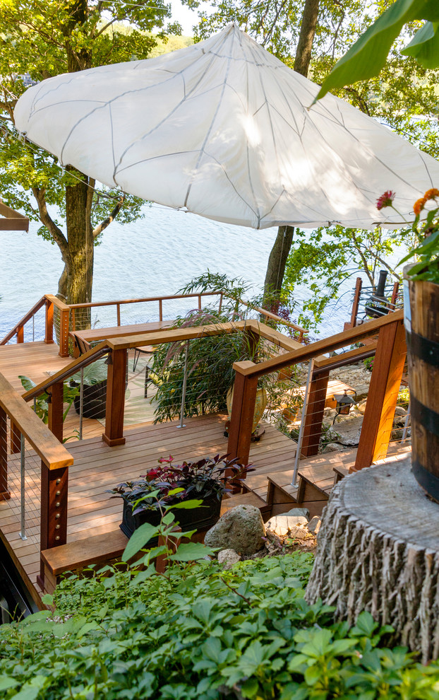 Large transitional backyard deck photo in New York with no cover