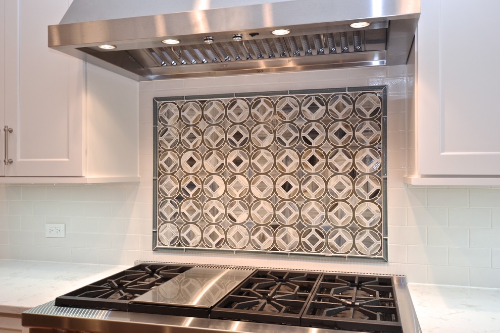 Transitional medium tone wood floor kitchen photo in Chicago with an undermount sink, recessed-panel cabinets, white cabinets, quartz countertops, stainless steel appliances and an island