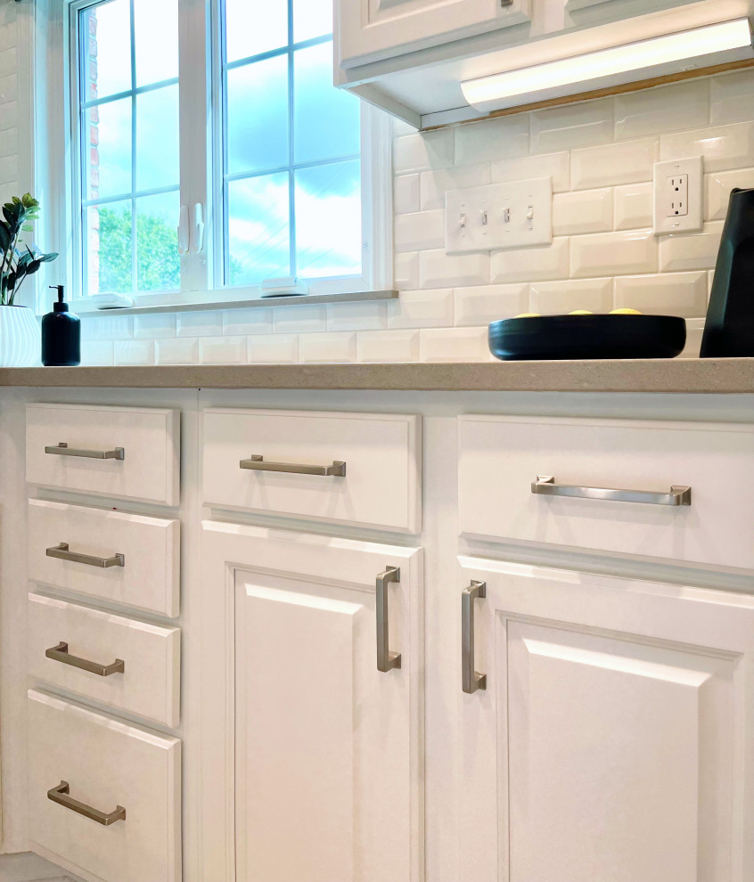 Inspiration for a large transitional u-shaped ceramic tile and beige floor open concept kitchen remodel with an undermount sink, recessed-panel cabinets, white cabinets, quartz countertops, white backsplash, ceramic backsplash, stainless steel appliances, an island and gray countertops