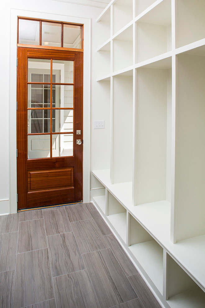 Inspiration for a transitional ceramic tile mudroom remodel in Charleston with white walls and a medium wood front door