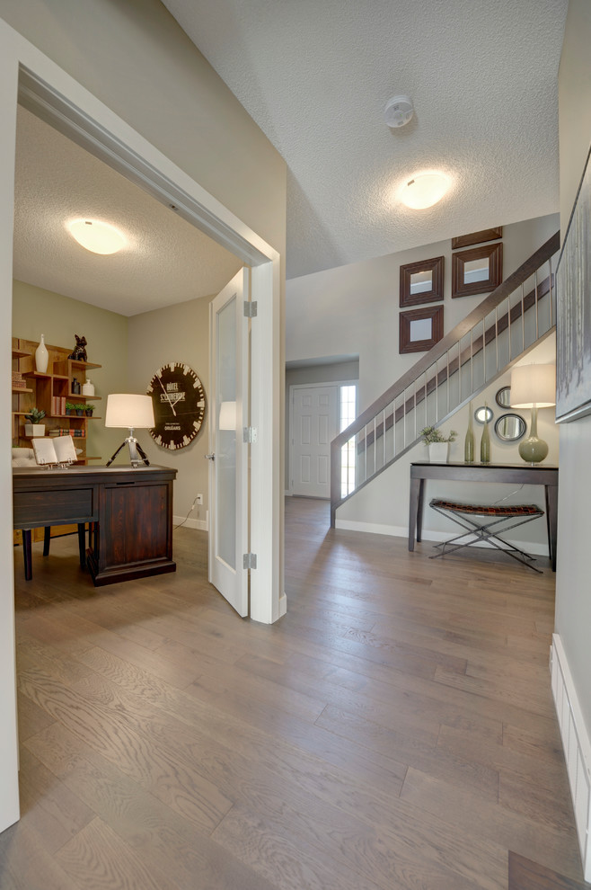 Foyer - mid-sized transitional light wood floor and brown floor foyer idea in Edmonton with gray walls and a gray front door