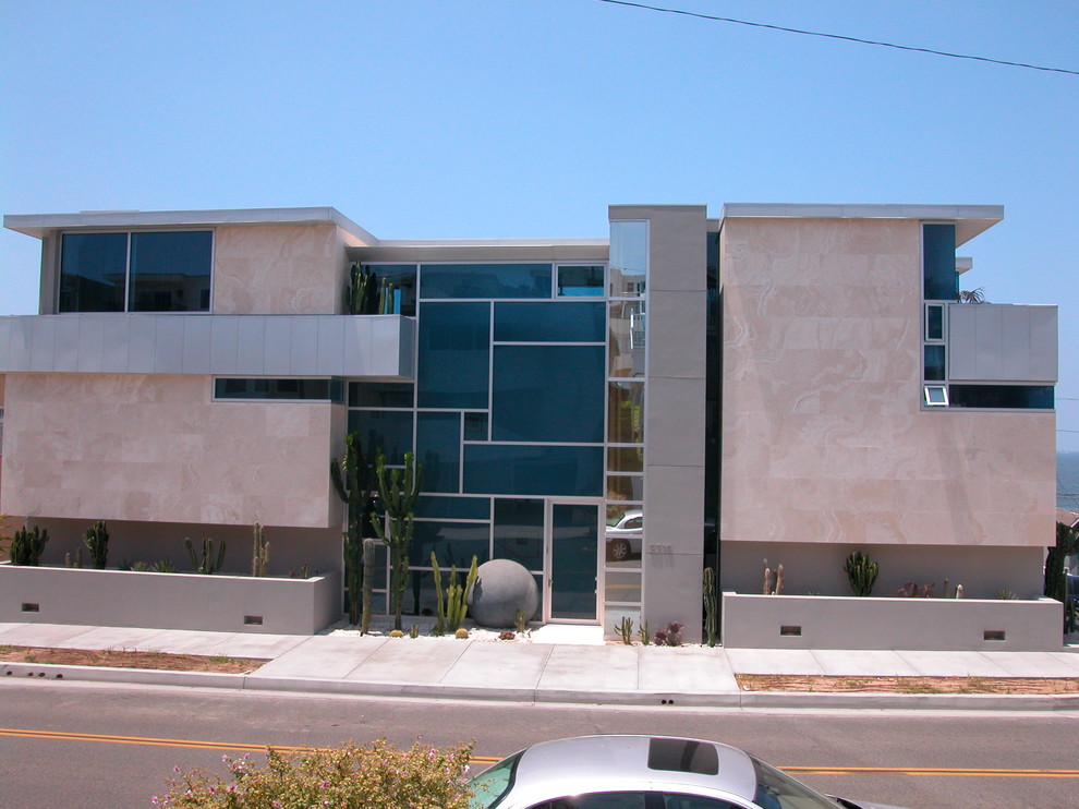 This is an example of a large contemporary three-storey stucco grey house exterior in Los Angeles.