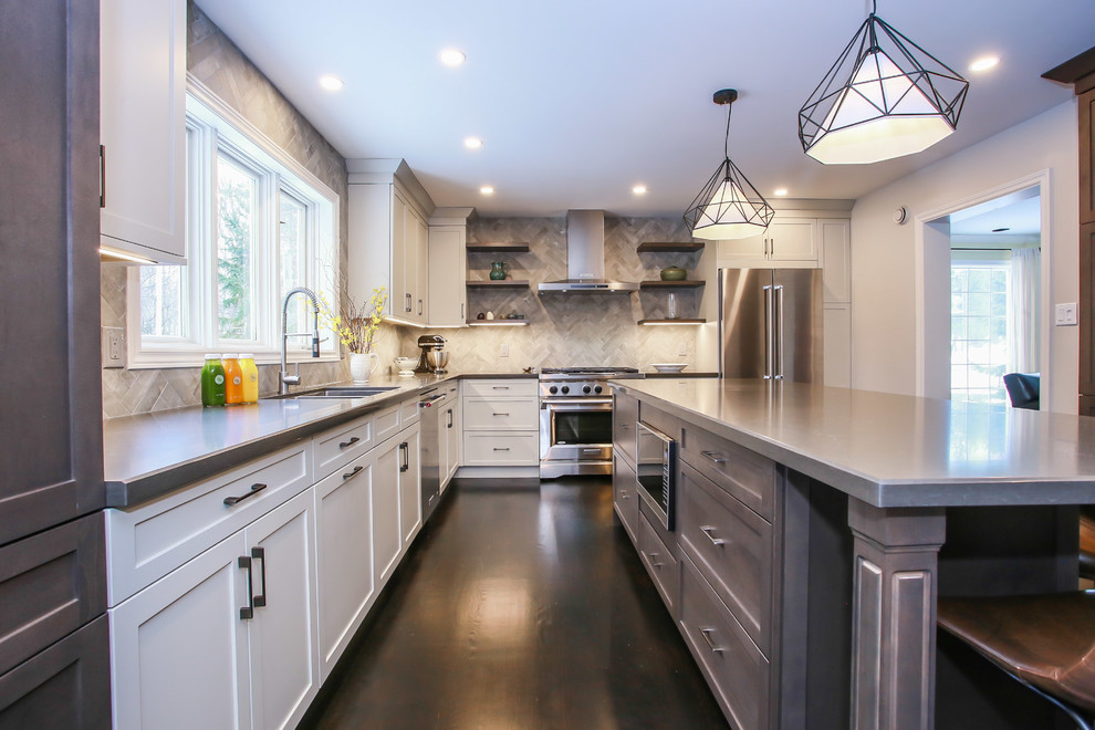Example of a large transitional l-shaped dark wood floor and brown floor eat-in kitchen design in Toronto with an undermount sink, shaker cabinets, gray cabinets, quartz countertops, gray backsplash, porcelain backsplash, stainless steel appliances and an island