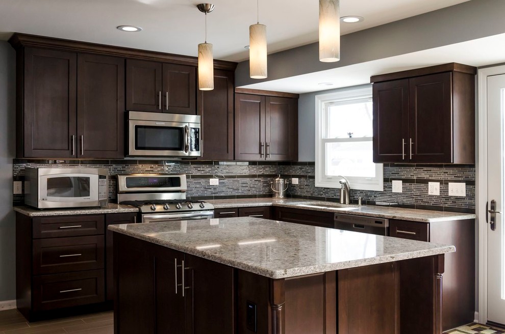 Inspiration for a mid-sized transitional l-shaped porcelain tile open concept kitchen remodel in Chicago with an undermount sink, raised-panel cabinets, dark wood cabinets, quartz countertops, beige backsplash, stainless steel appliances and blue walls
