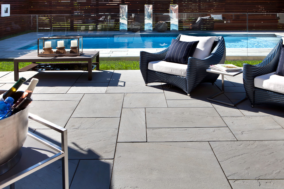 Design ideas for a large contemporary backyard patio in Montreal with no cover.