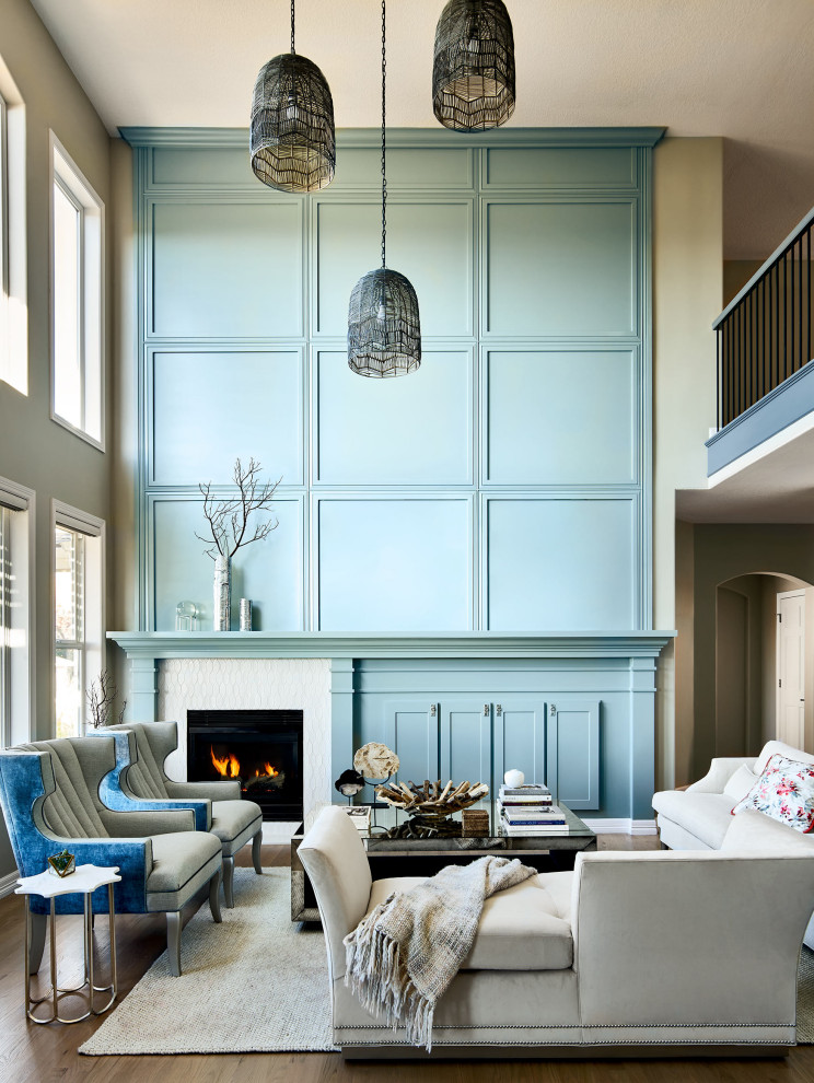 Inspiration for a large transitional formal open concept living room in Denver with blue walls, light hardwood floors, a corner fireplace, a tile fireplace surround, a built-in media wall, brown floor and decorative wall panelling.