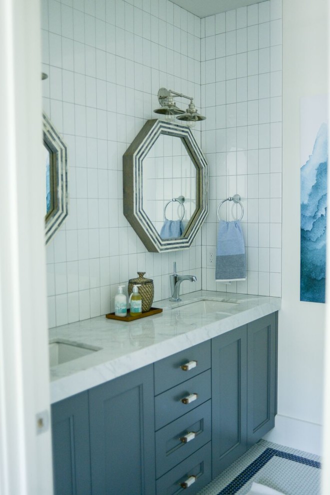 Mid-sized scandinavian kids bathroom in San Diego with recessed-panel cabinets, grey cabinets, a drop-in tub, a shower/bathtub combo, a one-piece toilet, white tile, subway tile, white walls, mosaic tile floors, an undermount sink and marble benchtops.