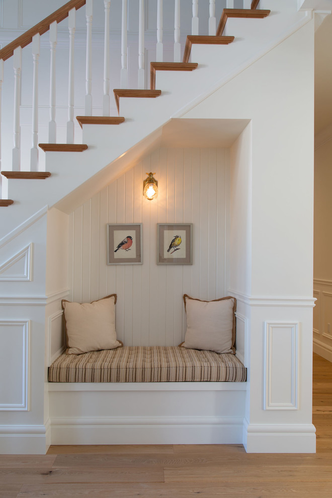 Photo of a small scandinavian straight staircase in Toronto with wood risers and wood railing.