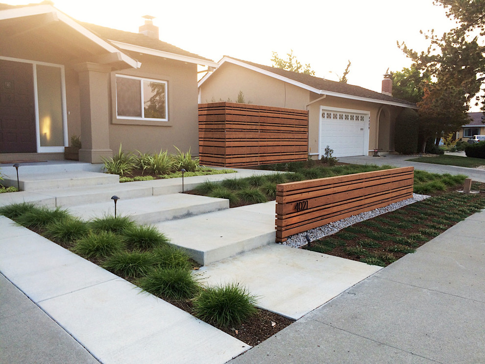 This is an example of a contemporary front yard partial sun xeriscape in San Francisco with concrete pavers.