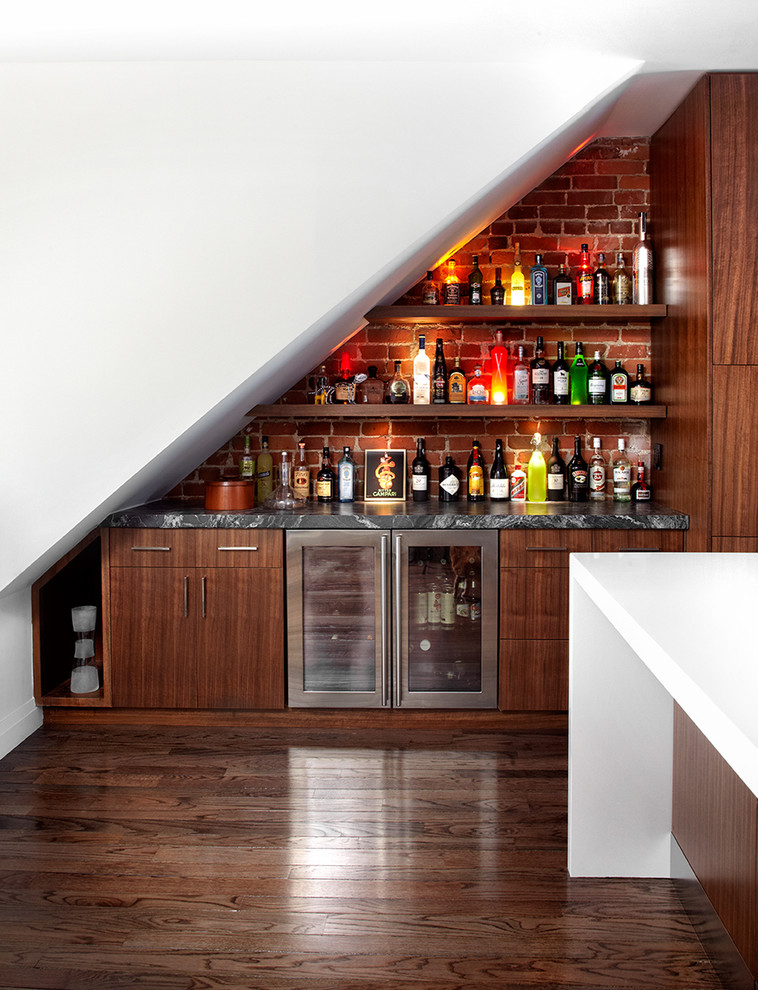 Mid-sized contemporary single-wall home bar in Toronto with flat-panel cabinets, dark wood cabinets, marble benchtops, dark hardwood floors, brick splashback and red splashback.