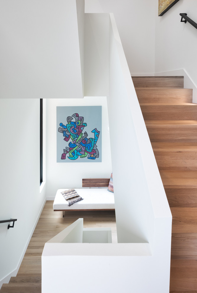 Design ideas for a contemporary wood u-shaped staircase in Minneapolis with wood risers.