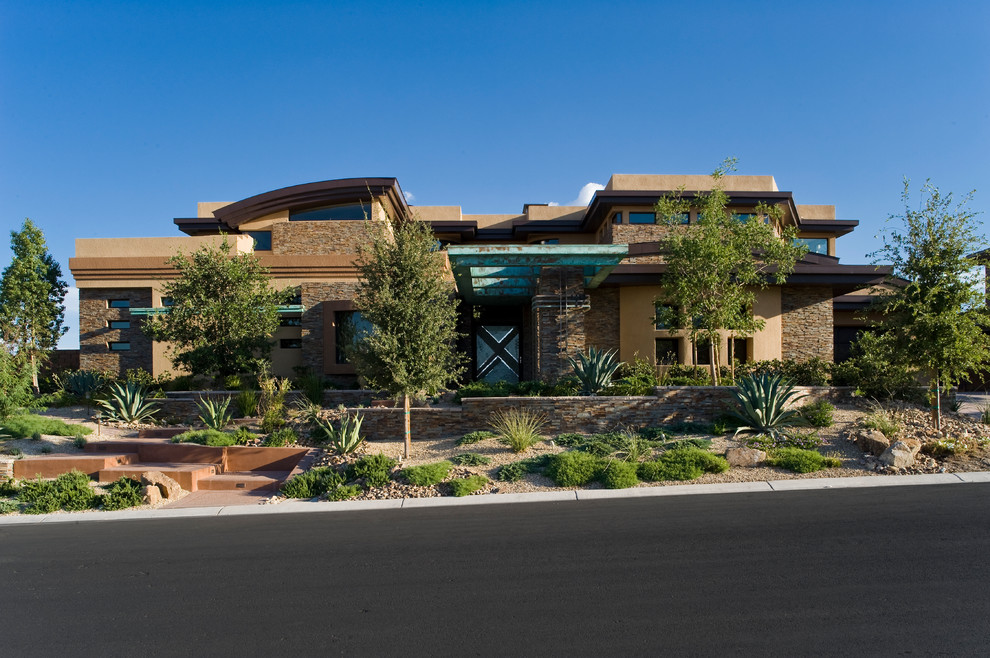Contemporary two-storey brown exterior in Las Vegas with mixed siding.