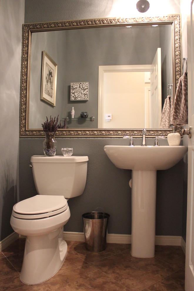 Design ideas for a mid-sized transitional powder room in Los Angeles with a two-piece toilet, porcelain floors, a pedestal sink and brown tile.