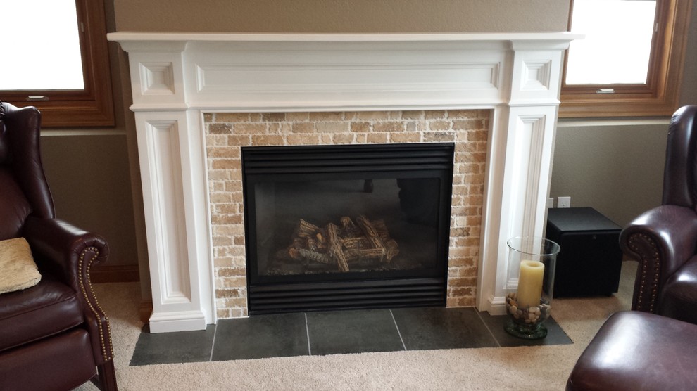 Inspiration for a mid-sized transitional walk-out carpeted basement remodel with beige walls, a standard fireplace and a stone fireplace