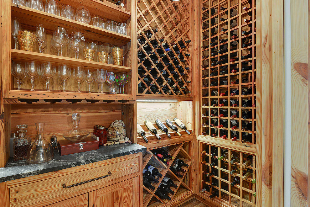 This is an example of a mid-sized transitional wine cellar in New Orleans with storage racks.