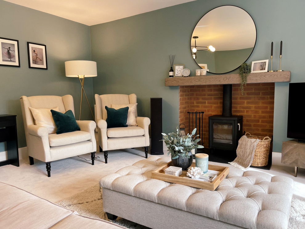 Inspiration for a medium sized contemporary formal enclosed living room in Hampshire with blue walls, carpet, a wood burning stove, a wooden fireplace surround, a freestanding tv, grey floors and feature lighting.