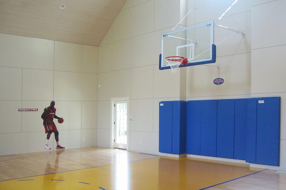 This is an example of a large traditional indoor sport court in Boston with beige walls, light hardwood floors and beige floor.