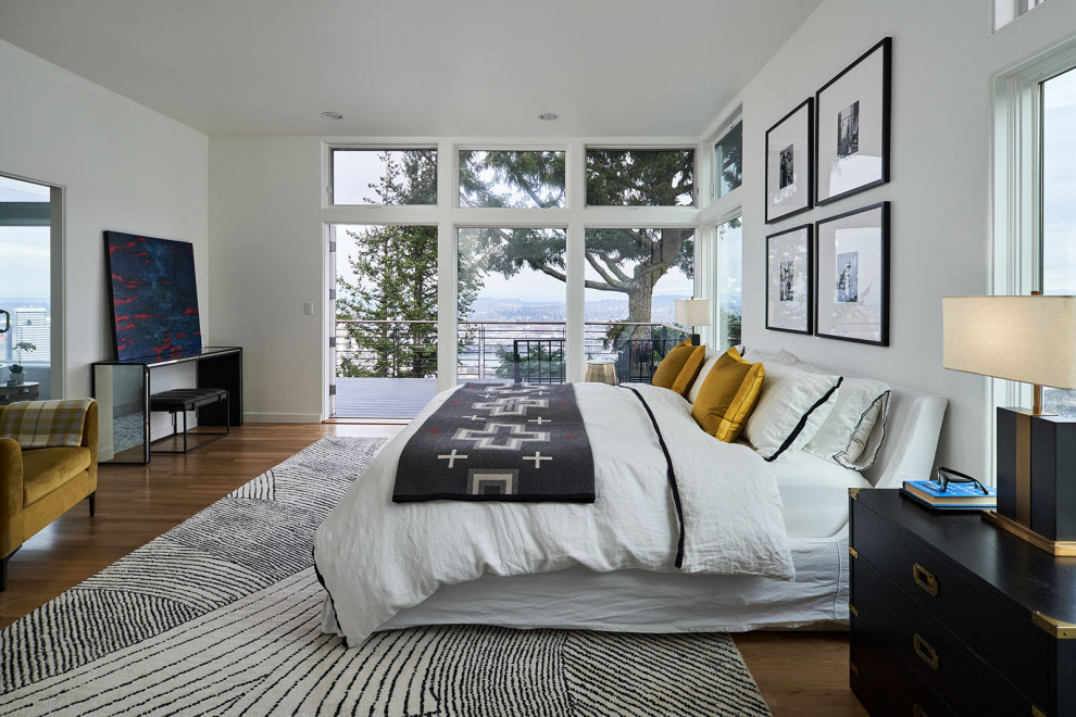 Photo of a mid-sized transitional master bedroom in Portland with white walls and medium hardwood floors.