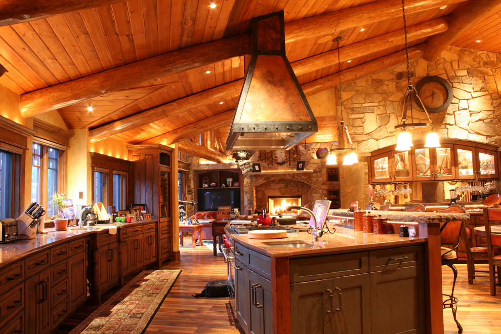 This is an example of an expansive country galley eat-in kitchen in Denver with an undermount sink, shaker cabinets, distressed cabinets, granite benchtops, stone slab splashback, stainless steel appliances, medium hardwood floors and multiple islands.