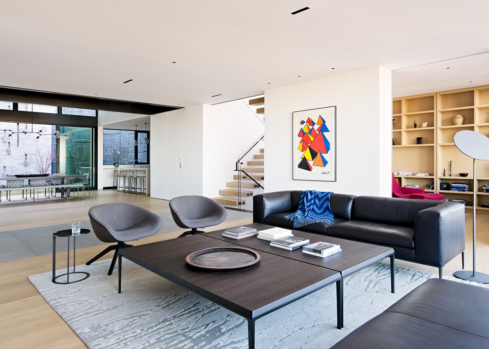 Photo of a modern open concept living room in San Francisco with white walls, light hardwood floors and beige floor.