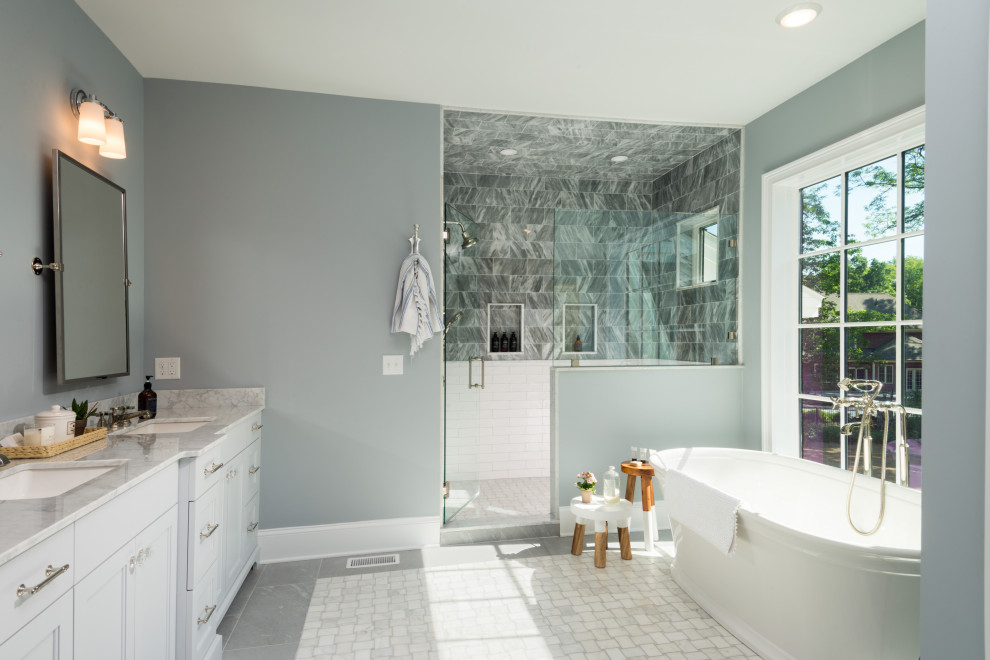 Design ideas for a contemporary ensuite bathroom in Boston with beaded cabinets, white cabinets, a freestanding bath, a two-piece toilet, marble flooring, a built-in sink, engineered stone worktops, a hinged door, a shower bench, double sinks and a freestanding vanity unit.