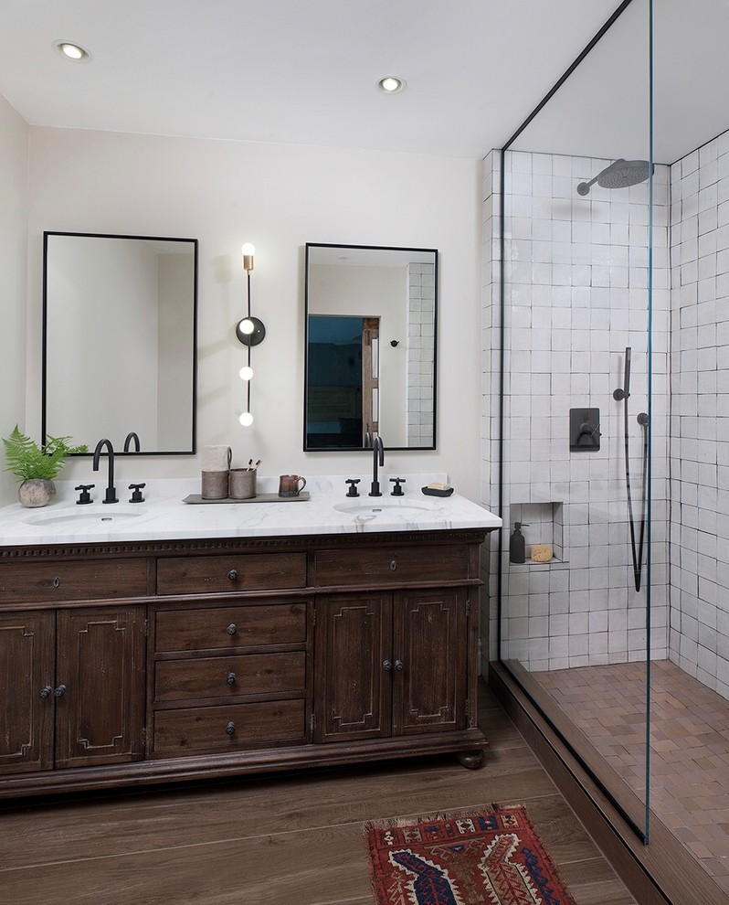 This is an example of a mid-sized country master bathroom in San Francisco with medium wood cabinets, an open shower, white tile, ceramic tile, white walls, porcelain floors, an undermount sink, marble benchtops, brown floor, an open shower, white benchtops and recessed-panel cabinets.