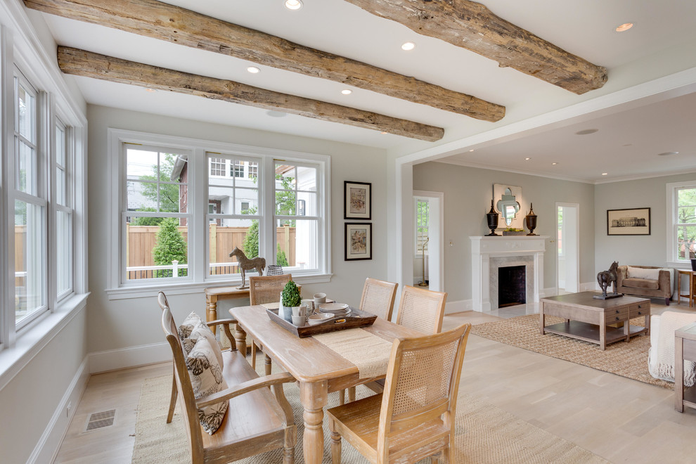 Inspiration for a mid-sized traditional open plan dining in DC Metro with beige walls, light hardwood floors, a standard fireplace and a stone fireplace surround.