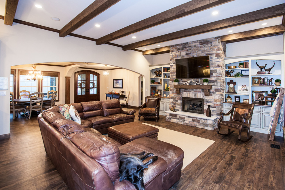 Large country open concept family room in St Louis with beige walls, dark hardwood floors, a standard fireplace and a brick fireplace surround.