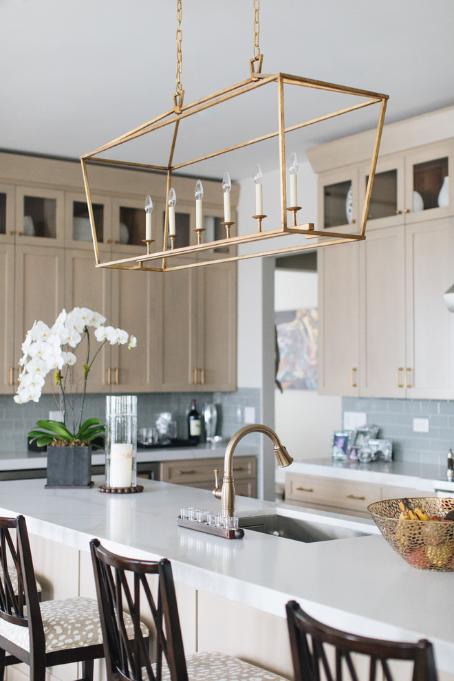 Large transitional u-shaped medium tone wood floor and brown floor kitchen photo in Chicago with an undermount sink, shaker cabinets, beige cabinets, quartz countertops, glass tile backsplash, stainless steel appliances, an island and white countertops