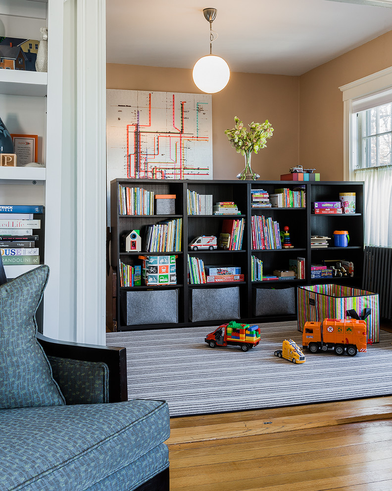 This is an example of a mid-sized traditional gender-neutral kids' playroom for kids 4-10 years old in Boston with medium hardwood floors and brown walls.