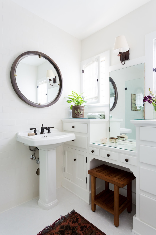 Inspiration for a small arts and crafts 3/4 bathroom in Los Angeles with white cabinets, white tile, ceramic tile, white walls, a pedestal sink, glass benchtops, white floor, white benchtops and shaker cabinets.