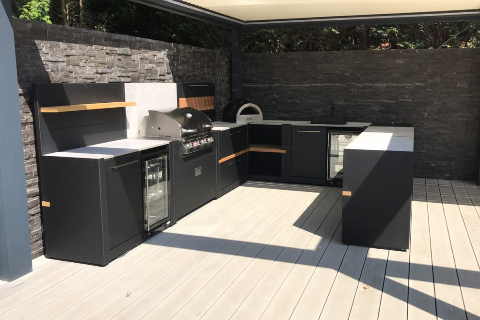 Large back patio in Manchester with an outdoor kitchen, decking and a pergola.