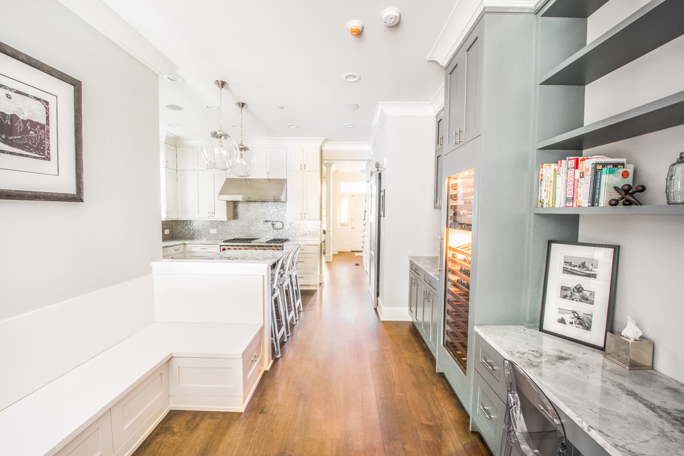 Inspiration for a mid-sized transitional l-shaped dark wood floor open concept kitchen remodel in Chicago with a double-bowl sink, shaker cabinets, white cabinets, quartzite countertops, metallic backsplash, metal backsplash, stainless steel appliances and a peninsula