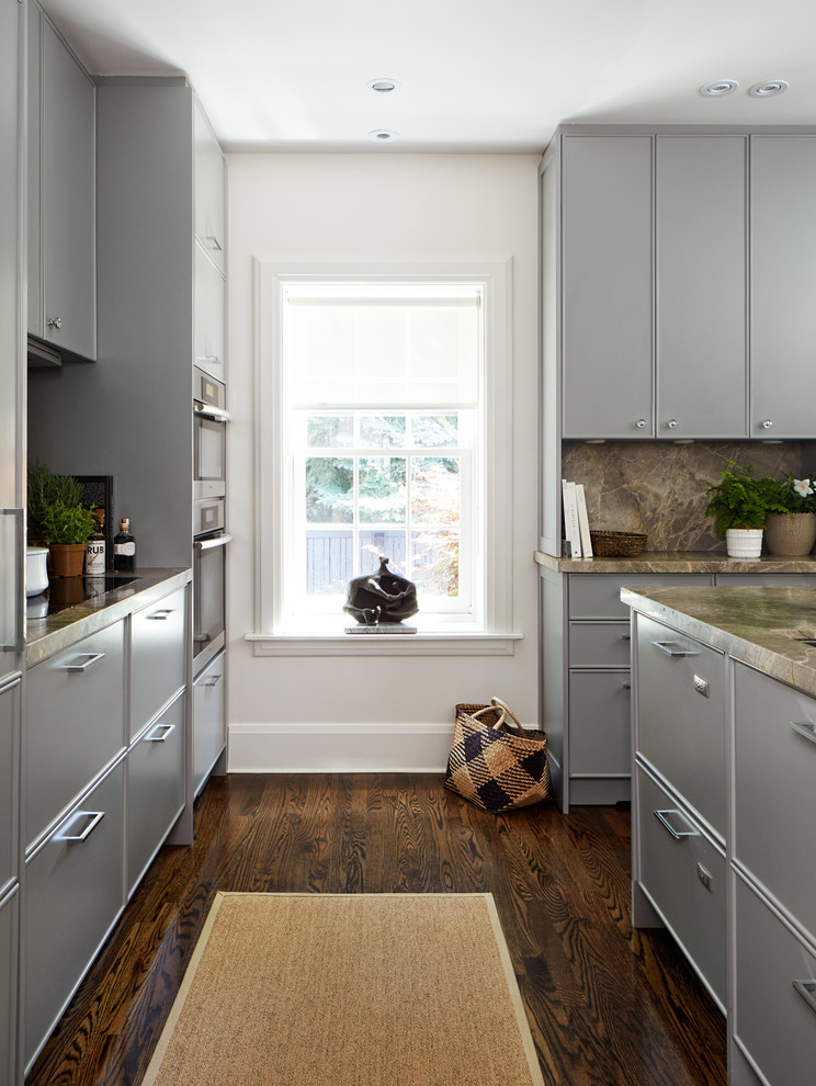 Small traditional galley eat-in kitchen in Toronto with grey cabinets, marble benchtops, grey splashback, stone slab splashback, stainless steel appliances, medium hardwood floors, an undermount sink, beaded inset cabinets and with island.