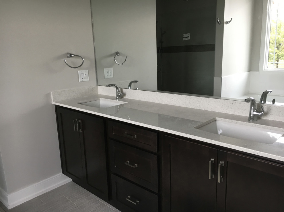 This is an example of a modern master bathroom in Other with shaker cabinets, dark wood cabinets, grey walls, porcelain floors, an undermount sink, engineered quartz benchtops, grey floor and beige benchtops.